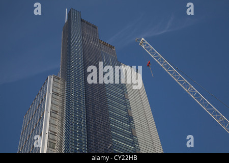 Tower crane next to Heron Tower against blue sky City of London Stock Photo