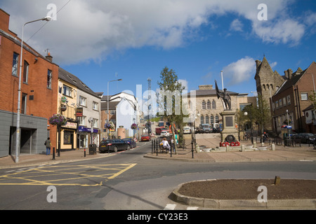 Dungannon Co Tyrone Northern Ireland War memorial in town square with ornate former police barracks in right hand corner Stock Photo