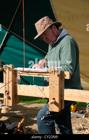 Pole lathe turning making chair spindles demonstration at   Weald and Downland Open Air Museum, Chichester,West Sussex, Stock Photo