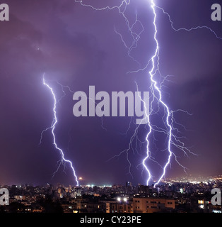 Photo of beautiful powerful lightning over big city, zipper and thunderstorm, abstract background, dark blue sky Stock Photo