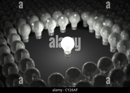 Single lit light bulb stading out in a crowd. Stock Photo