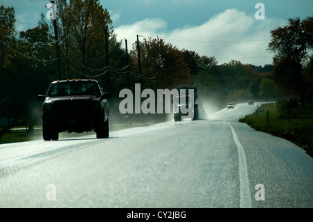 Highway traffic on wet road. Stock Photo
