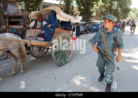 Afghan national Police officers walking patrol in Khanabad, Kunduz. Dutch military are supervising them. Stock Photo