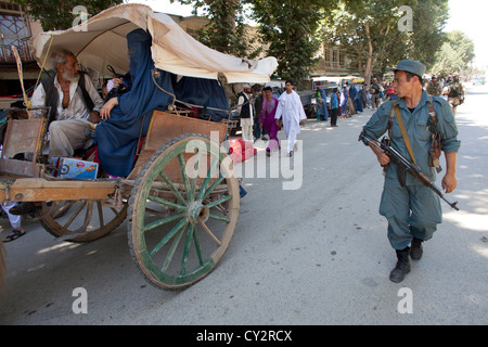 Afghan national Police officers walking patrol in Khanabad, Kunduz. Dutch military are supervising them. Stock Photo