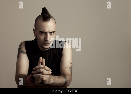 portrait of a tattooed young man with punk style hair Stock Photo