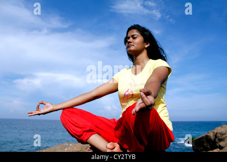 Indian woman performing yogasana Stock Photo