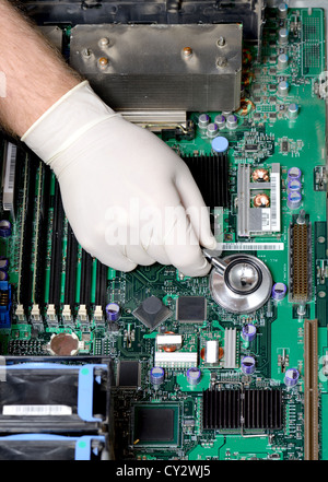 Silver stethoscope lying down on an server motherboard Stock Photo