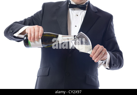 Man in Tuxedo Pouring Champagne isolated over white Stock Photo