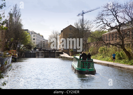 Traditional narrow boat approaches a lock on the Regents Canal in Hackney, Central London Stock Photo