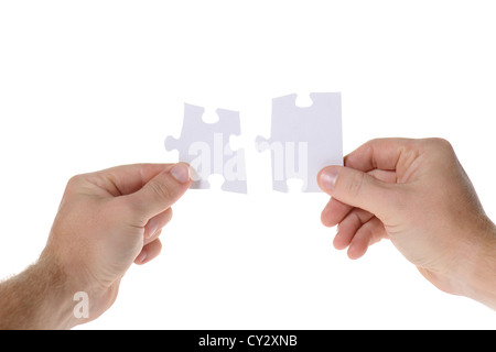 Hands with two puzzles. Isolated on white background Stock Photo