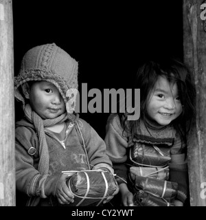 Black Hmong Kids Holding Wrapped Rice Cakes For Tet, Sapa, Vietnam Stock Photo