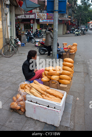 Woman Selling Bread In The Street, Hanoi, Vietnam Stock Photo