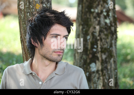 Man sat in park thinking Stock Photo