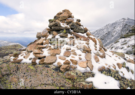 Cairn partially covered by snow on the Franconia Ridge trail, White mountains, New Hampshire, USA. Stock Photo