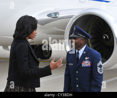 First lady Michelle Obama is greeted by Air National Guard Chief Master Sgt. Marlin Mosley upon her arrival at the 128th Air Refueling Wing in Milwaukee Friday, Oct. 19, 2012.Obama arrived at the Wisconsin Air National Guard base prior to making appearances in Racine and Wausau. Stock Photo