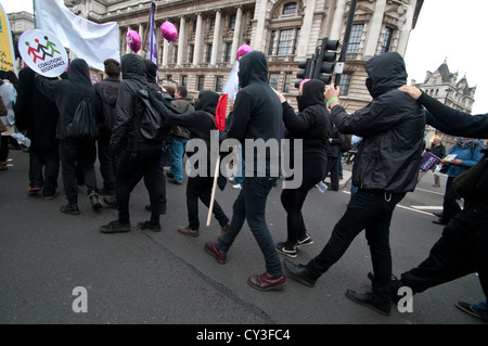 Black Bloc activists try to confuse the police as they weave their way through the TUC march on 20th October 2012 Stock Photo