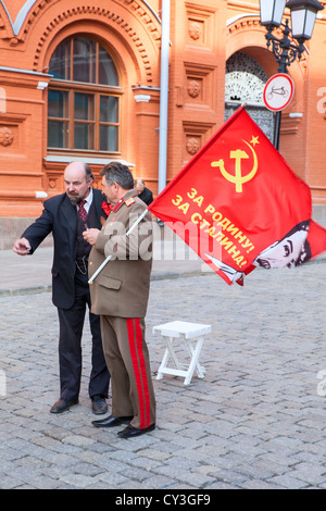 Lenin and Stalin standing together on Red Square. Actors who playing for donation near the Kremlin in Moscow, Russia Stock Photo