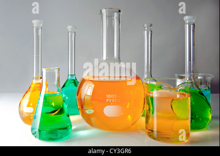 Glass lab flasks filled with colored liquids. Stock Photo