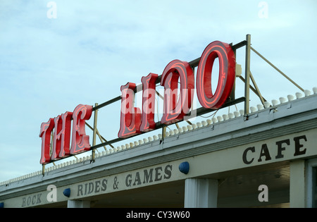 The Lido on Worthing seafront West Sussex UK . The old swimming pool is now used as an amusement arcade and small funfair rides Stock Photo