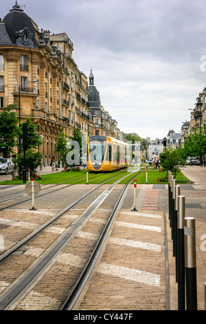 Tram running down the center of Cours Jean Baptiste Langlet in Reims France Stock Photo