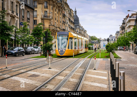 Tram running down the center of Cours Jean Baptiste Langlet in Reims France Stock Photo