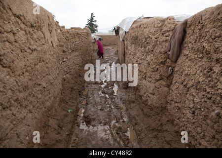 Afghan boy walking in a slum of kabul Stock Photo
