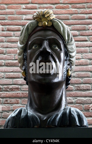 Dutch 17 the century shop sign for apothecaries and druggists.open mouth miming swallowing pills.Gaper Stock Photo