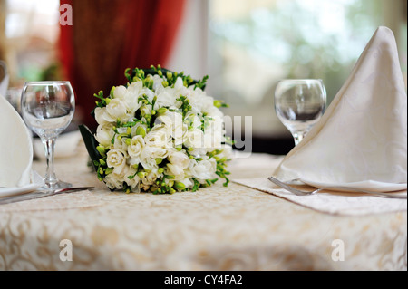wedding bouquet on a served table in restaurant Stock Photo