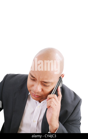 Portrait of a serious businessman talking on mobile phone over white background Stock Photo