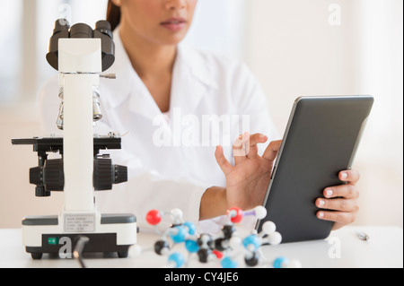 USA, New Jersey, Jersey City, Female scientist working on tablet PC Stock Photo