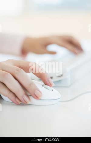 USA, New Jersey, Jersey City, Close up of woman's hands using computer keyboard and computer mouse Stock Photo