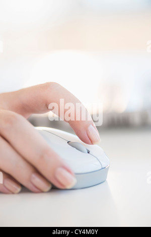 USA, New Jersey, Jersey City, Close up of woman's hands using computer mouse Stock Photo