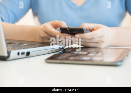 USA, New Jersey, Jersey City, Close up of woman's hands using multiple devices Stock Photo
