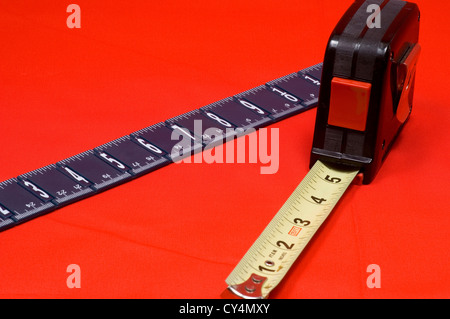 Measuring tape and ruler on red background Stock Photo
