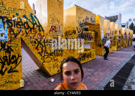 Kosovar girl by Newborn obelisk, placed in Pristina downtown on February 17th 2008 when Kosovo declared independence from Serbia Stock Photo