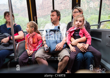 Young parents with children riding a bus/shuttle in Zion NPS Stock Photo