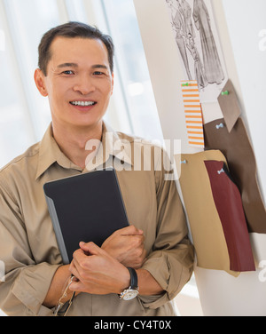 USA, New Jersey, Jersey City, Mid adult fashion designer using digital tablet Stock Photo