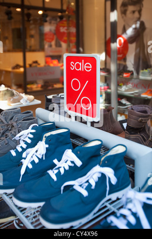 sale signs advertising low prices in shoe retail store Stock Photo