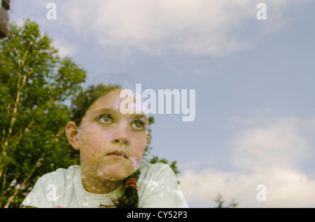USA, New York State, Hudson, girl (8-9) looking through window Stock Photo