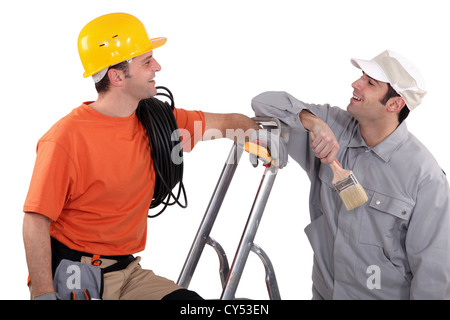 a house painter and an electrician laughing Stock Photo