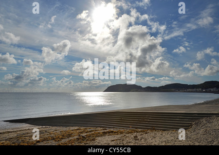 Dramatic blue sky & clouds morning seascape & sunrise view from Llandudno seafront towards Little Orme headland Llandudno Conwy Clwyd North Wales UK Stock Photo