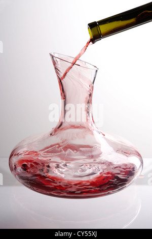 Red wine being poured into a decanter Stock Photo