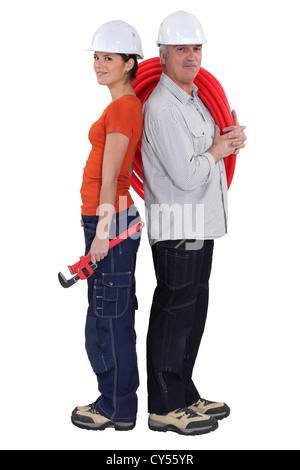 Young and old plumbers Stock Photo