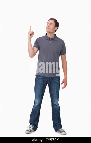 Young man pointing and looking up Stock Photo