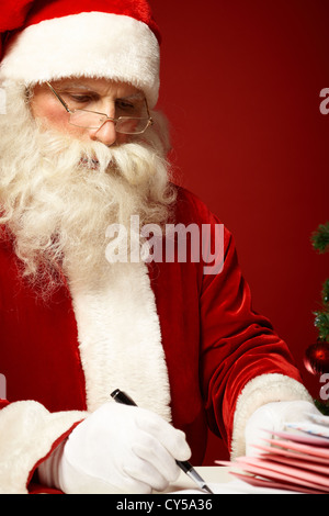 Portrait of Santa Claus answering Christmas letter Stock Photo