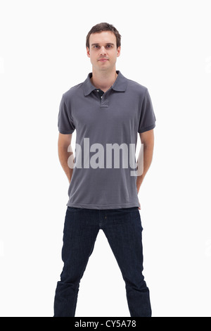 Close-up of a standing man with his hands behind his back and his legs apart Stock Photo