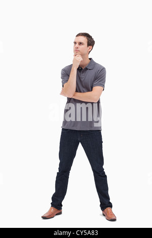 Thoughtful standing man and his legs apart Stock Photo