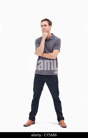 Thoughtful standing man with his legs apart Stock Photo