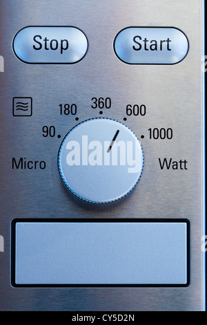 Close up of modern microwave control panel, blue light Stock Photo