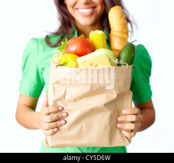 Image of big paper sack full of different fruits and vegetables in female hands Stock Photo